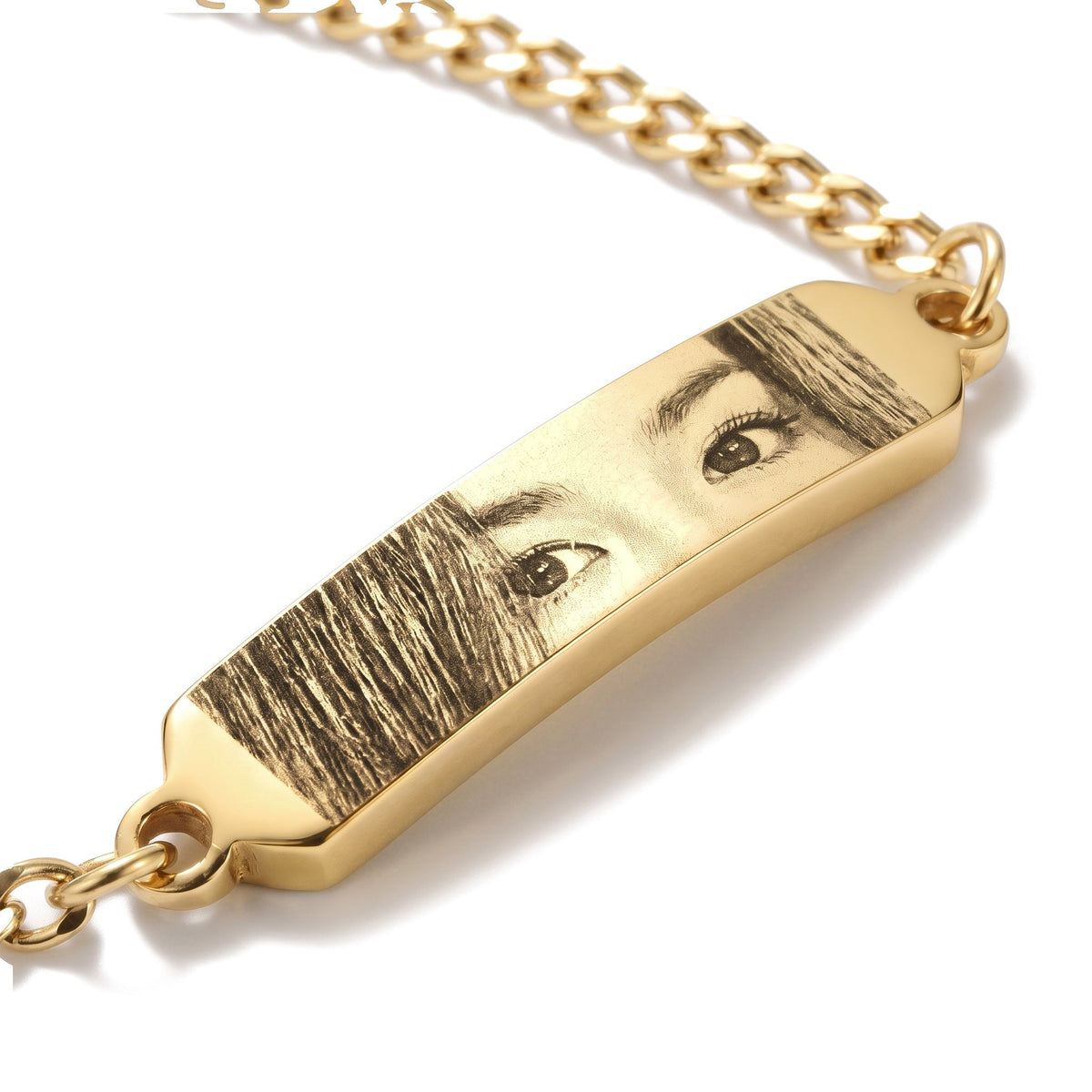 Close-up of the eye engraving on the gold bracelet bar