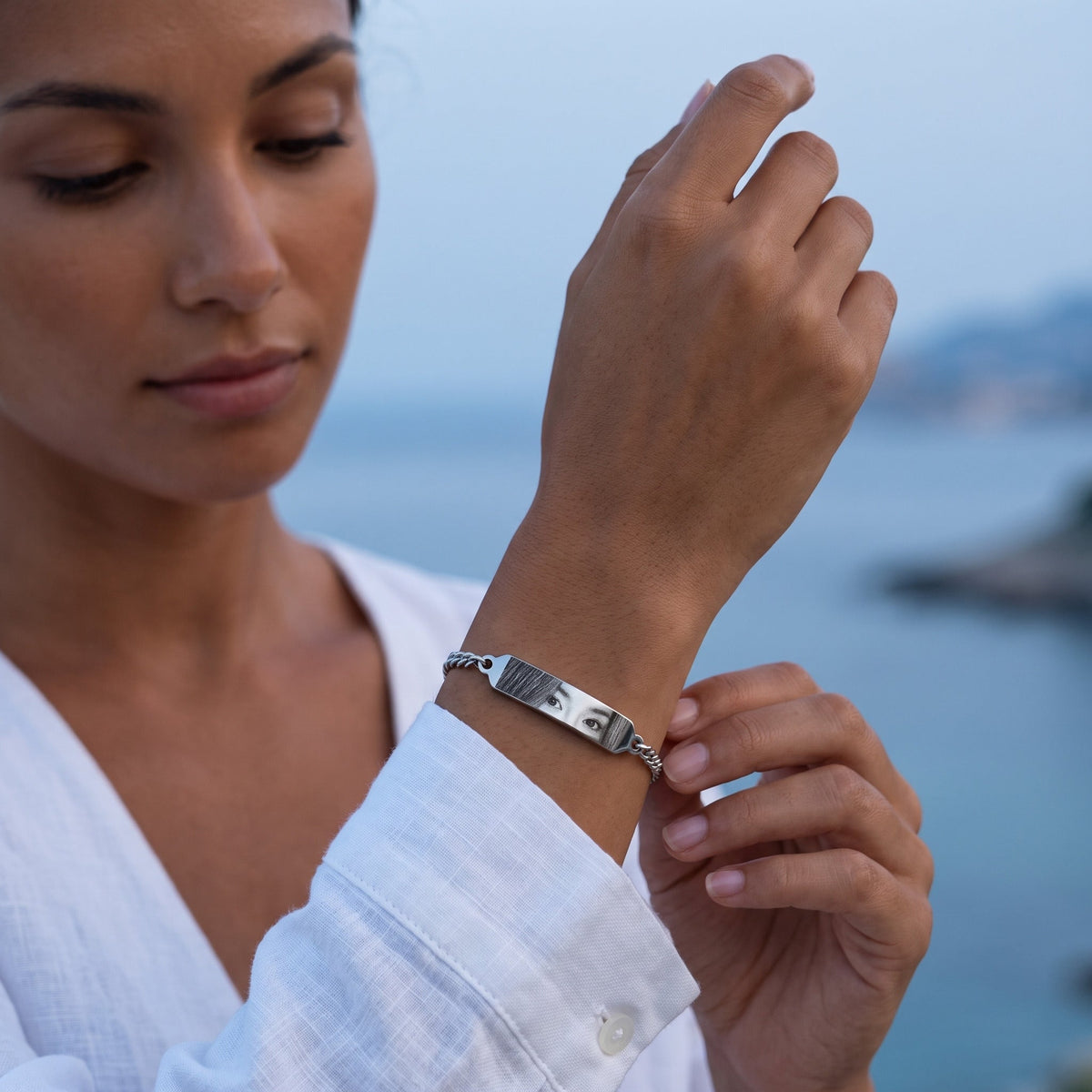 Woman wearing the silver eye bracelet with photo engraving